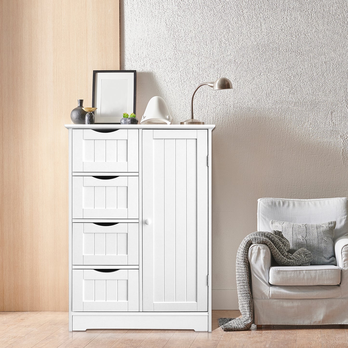 White 4-drawer storage cupboard used as an elegant console table in a living space, decorated with a lamp, framed art, and small plants.